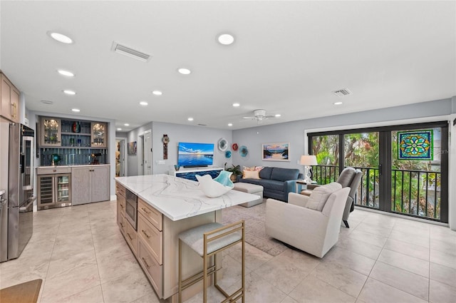 5806 Gulf Dr Unit 201S, Holmes Beach, FL 34217 - kitchen with stainless steel appliances, recessed lighting, a center island, beverage cooler, and light stone countertops
