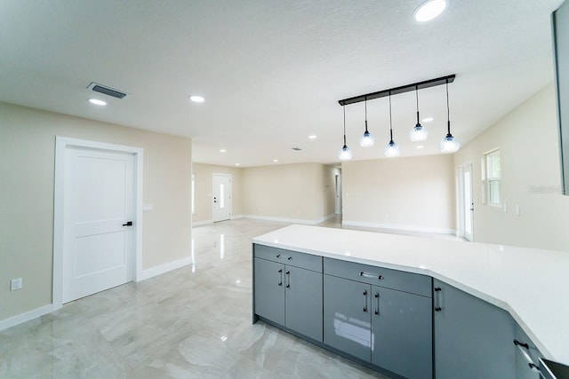 4616 34th Ave E, Bradenton, FL 34208 - kitchen featuring gray cabinetry, pendant lighting, open floor plan, recessed lighting, and light countertops