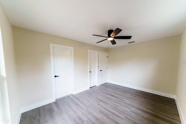 4616 34th Ave E, Bradenton, FL 34208 - unfurnished bedroom with wood finished floors and a ceiling fan