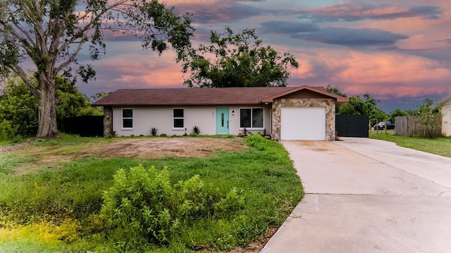 4616 34th Ave E, Bradenton, FL 34208 - single story home with stone siding, a garage, driveway, and stucco siding