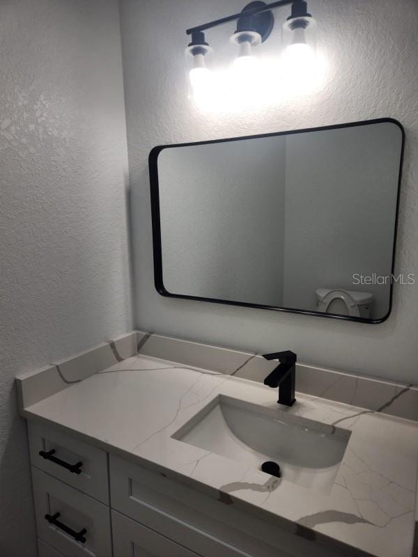 13074 SW 104th Ln, Dunnellon, FL 34432 - bathroom with a textured wall and vanity