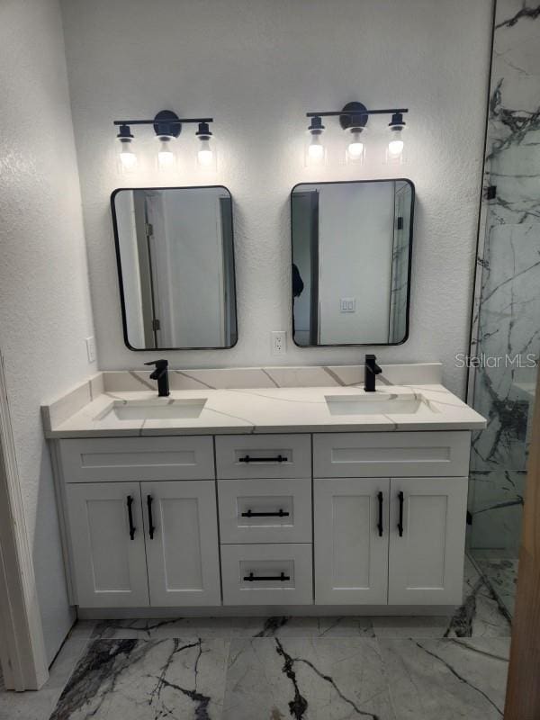 13074 SW 104th Ln, Dunnellon, FL 34432 - bathroom with marble look tiles, double vanity, a textured wall, and a marble finish shower
