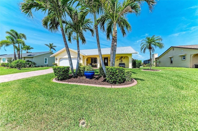4508 Mangrove Point Rd, Bradenton, FL 34210 - single story home with driveway, an attached garage, a front lawn, metal roof, and stucco siding