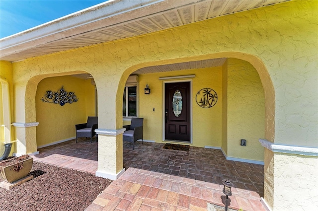 4508 Mangrove Point Rd, Bradenton, FL 34210 - property entrance with stucco siding and a porch