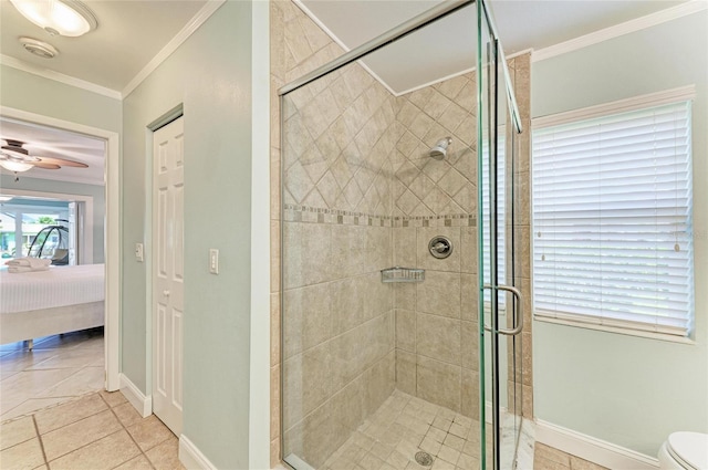 4508 Mangrove Point Rd, Bradenton, FL 34210 - ensuite bathroom with ornamental molding, tile patterned flooring, a stall shower, a ceiling fan, and toilet