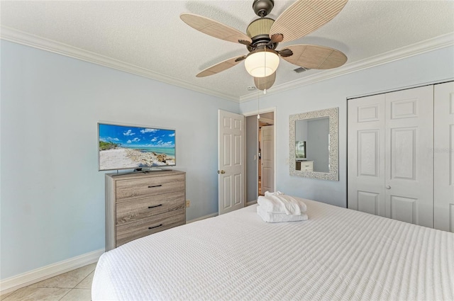 4508 Mangrove Point Rd, Bradenton, FL 34210 - bedroom featuring a closet, crown molding, light tile patterned floors, a ceiling fan, and a textured ceiling