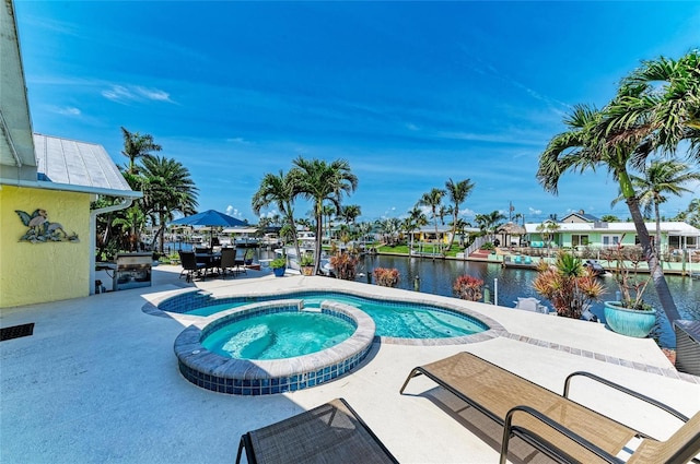 4508 Mangrove Point Rd, Bradenton, FL 34210 - view of swimming pool with a patio area, a water view, and a pool with connected hot tub