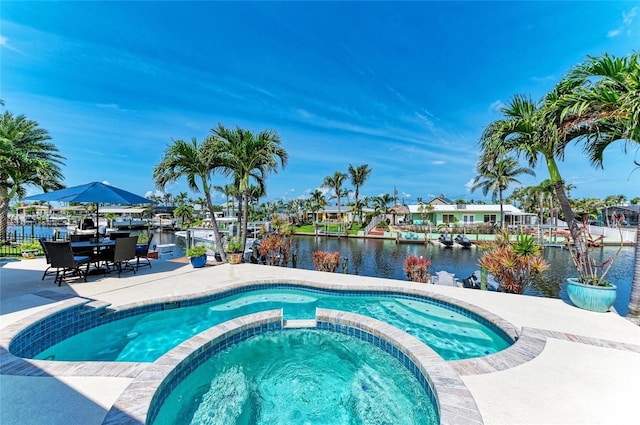 4508 Mangrove Point Rd, Bradenton, FL 34210 - view of swimming pool featuring a pool with connected hot tub, a water view, and a patio area