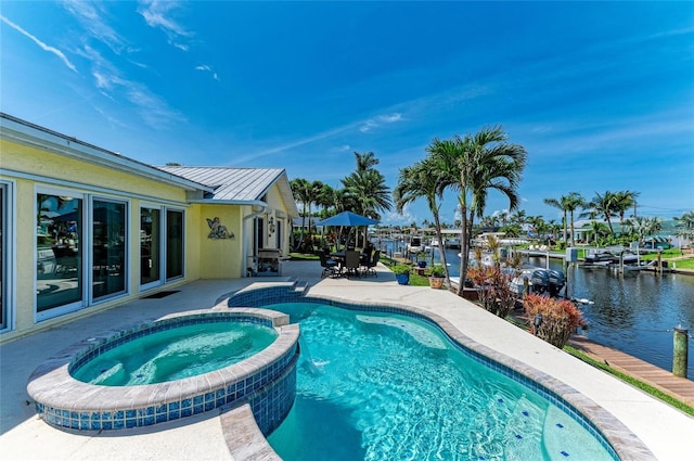 4508 Mangrove Point Rd, Bradenton, FL 34210 - view of pool with a patio area, a pool with connected hot tub, a water view, and outdoor dining area