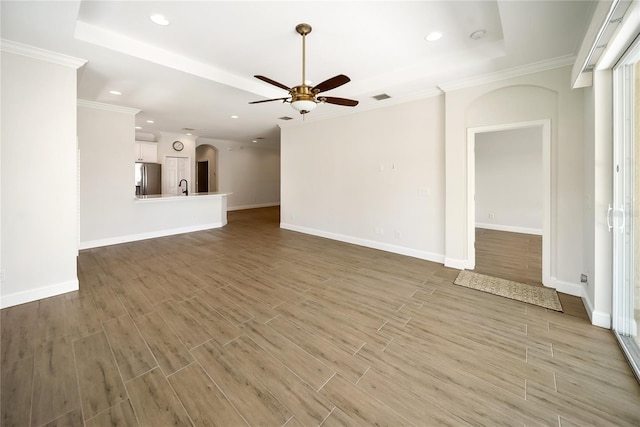 7403 Hamilton Rd, Bradenton, FL 34209 - unfurnished living room with a ceiling fan, recessed lighting, light wood finished floors, arched walkways, and baseboards