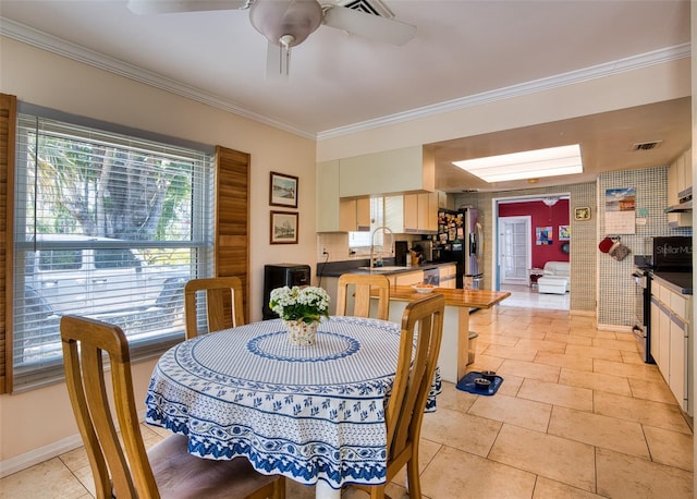 2216 Lake Shore Dr, Nokomis, FL 34275 - dining room featuring crown molding, healthy amount of natural light, ceiling fan, and light tile patterned floors