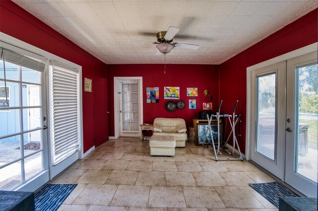 2216 Lake Shore Dr, Nokomis, FL 34275 - living area with french doors, ceiling fan, and light stone finish flooring