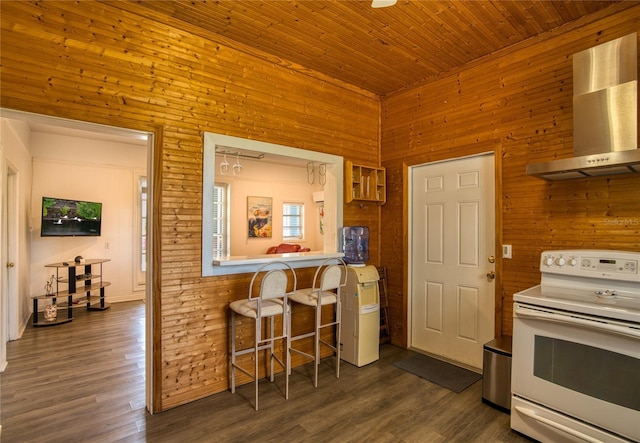 2216 Lake Shore Dr, Nokomis, FL 34275 - kitchen with wall chimney range hood, white range with electric cooktop, wood walls, a kitchen breakfast bar, and dark wood finished floors