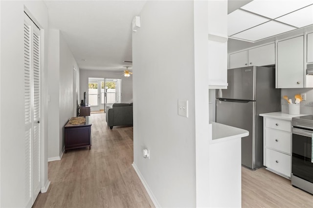 643 Park Cir, Bradenton, FL 34207 - kitchen featuring appliances with stainless steel finishes, light countertops, light wood-style floors, a ceiling fan, and open floor plan