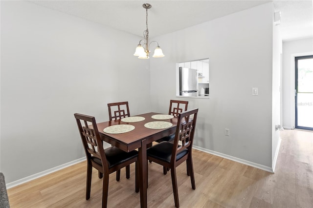 643 Park Cir, Bradenton, FL 34207 - dining room featuring a chandelier and light wood-style flooring