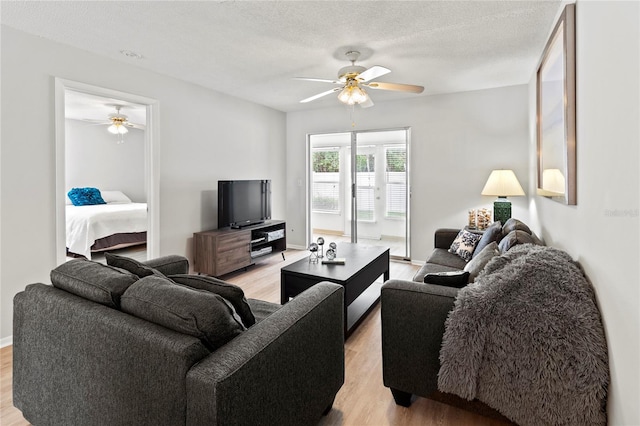 643 Park Cir, Bradenton, FL 34207 - living area with ceiling fan, light wood-style flooring, and a textured ceiling