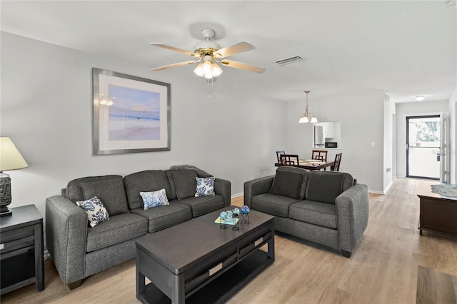 643 Park Cir, Bradenton, FL 34207 - living area with light wood-style floors and a ceiling fan
