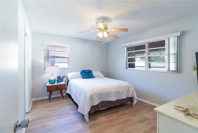 643 Park Cir, Bradenton, FL 34207 - bedroom featuring light wood-type flooring, a ceiling fan, and a textured ceiling