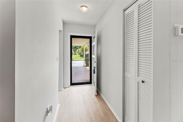 643 Park Cir, Bradenton, FL 34207 - hallway featuring light wood-type flooring and a textured ceiling