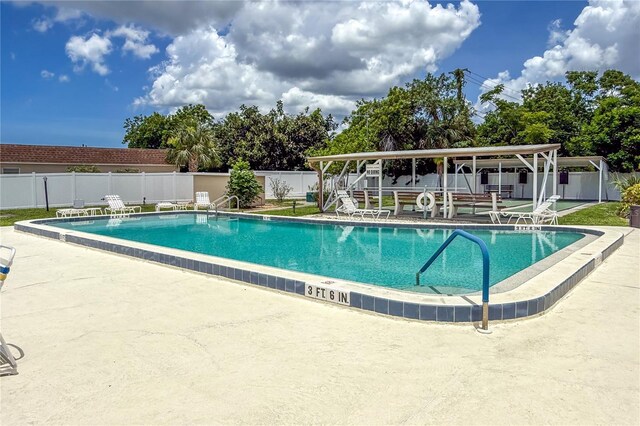 643 Park Cir, Bradenton, FL 34207 - community pool with a fenced backyard and a patio