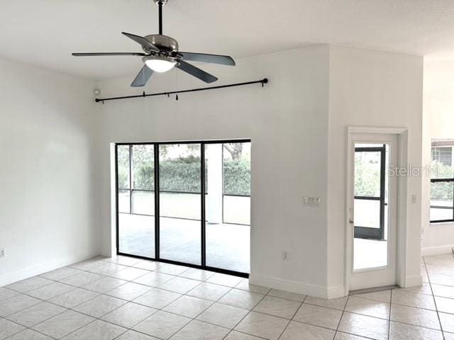11315 Cypress Shore Ct, Clermont, FL 34711 - unfurnished room featuring light tile patterned floors, a ceiling fan, and baseboards