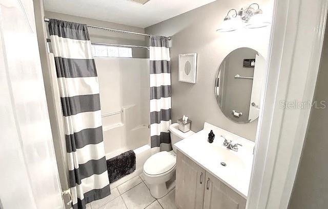 11315 Cypress Shore Ct, Clermont, FL 34711 - full bathroom with vanity, toilet, shower / tub combo, and tile patterned flooring