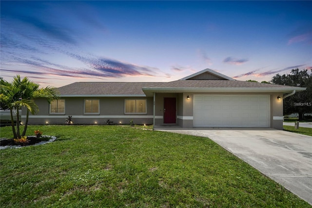 590 Ridgewood St NW, Port Charlotte, FL 33952 - single story home with stucco siding, a garage, concrete driveway, and a front yard