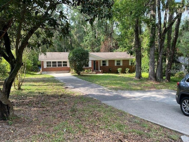 1616 NW 39th Ave, Gainesville, FL 32605 - view of front of house with driveway, a front yard, and brick siding