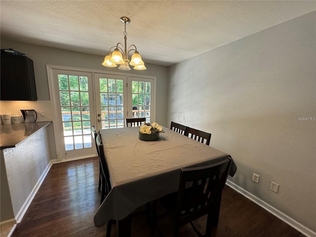 1616 NW 39th Ave, Gainesville, FL 32605 - dining space with a chandelier, dark wood-style flooring, a textured ceiling, and a textured wall