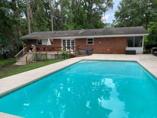 1616 NW 39th Ave, Gainesville, FL 32605 - swimming pool featuring french doors, a deck, stairs, and a patio area