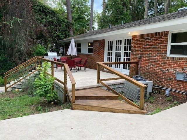 1616 NW 39th Ave, Gainesville, FL 32605 - wooden terrace featuring french doors, outdoor dining space, a patio area, and a grill