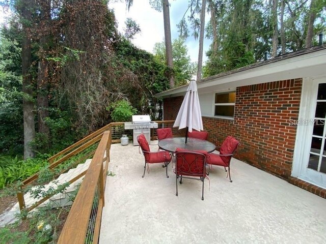 1616 NW 39th Ave, Gainesville, FL 32605 - view of patio / terrace featuring a grill and outdoor dining space