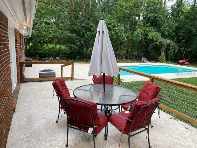 1616 NW 39th Ave, Gainesville, FL 32605 - view of patio with outdoor dining area and view of scattered trees