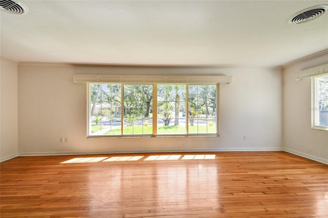 3001 Bay Shore Cir, Sarasota, FL 34234 - spare room featuring crown molding, hardwood / wood-style flooring, and baseboards