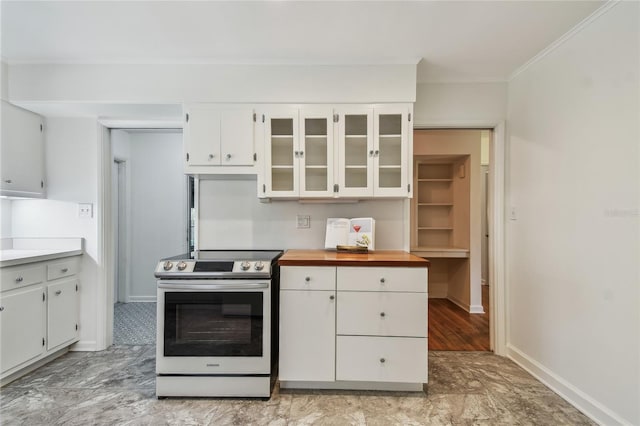 3001 Bay Shore Cir, Sarasota, FL 34234 - kitchen with stainless steel electric range oven, crown molding, white cabinets, glass insert cabinets, and baseboards