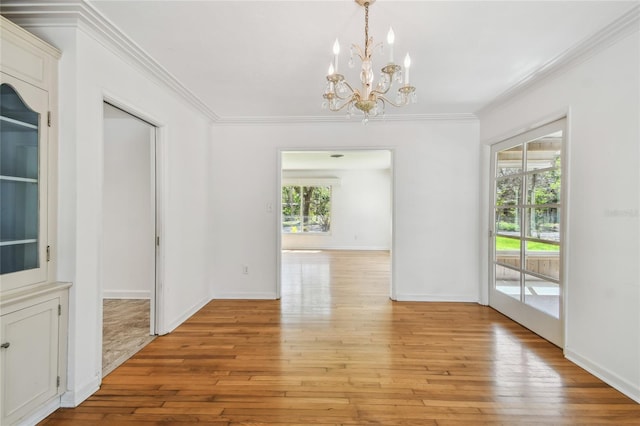 3001 Bay Shore Cir, Sarasota, FL 34234 - unfurnished room with a chandelier, crown molding, and light wood-type flooring