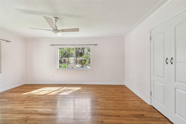 3001 Bay Shore Cir, Sarasota, FL 34234 - spare room featuring light wood-type flooring, a ceiling fan, ornamental molding, and baseboards