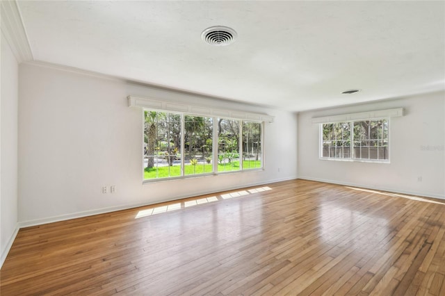 3001 Bay Shore Cir, Sarasota, FL 34234 - empty room featuring plenty of natural light, hardwood / wood-style flooring, baseboards, and ornamental molding