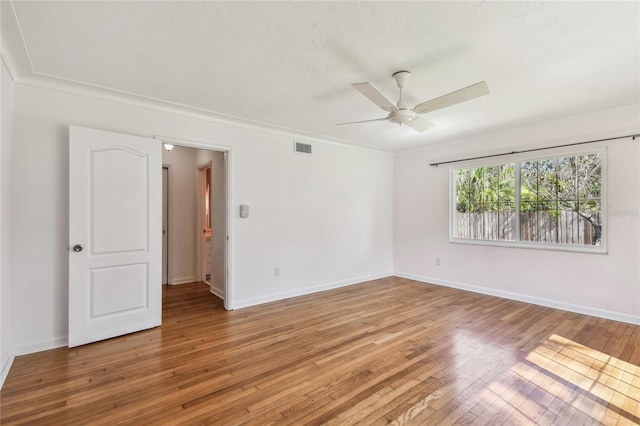 3001 Bay Shore Cir, Sarasota, FL 34234 - empty room with a ceiling fan, light wood-style floors, baseboards, and ornamental molding