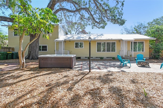 3001 Bay Shore Cir, Sarasota, FL 34234 - rear view of property with a hot tub, a patio area, and metal roof
