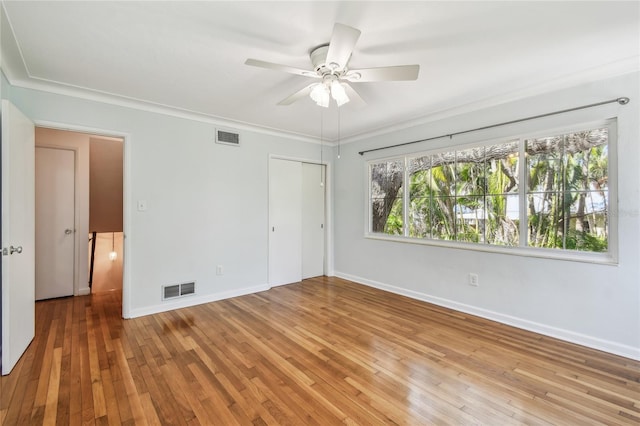 3001 Bay Shore Cir, Sarasota, FL 34234 - empty room with baseboards, hardwood / wood-style flooring, ceiling fan, and ornamental molding