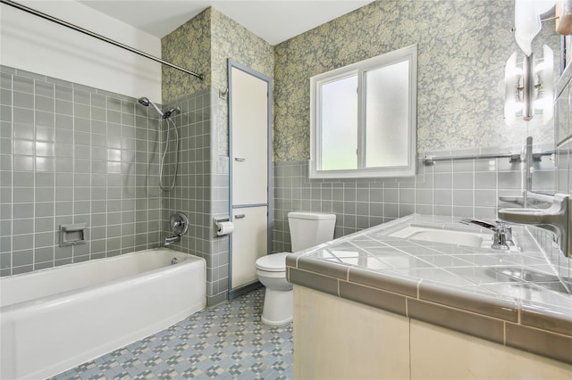 3001 Bay Shore Cir, Sarasota, FL 34234 - full bathroom with toilet, tile walls, tub / shower combination, vanity, and a wainscoted wall
