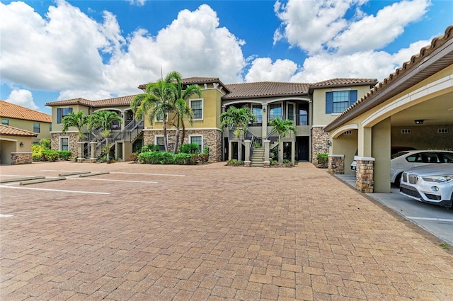 13609 Messina Loop Unit 104, Bradenton, FL 34211 - view of property with stairway and uncovered parking