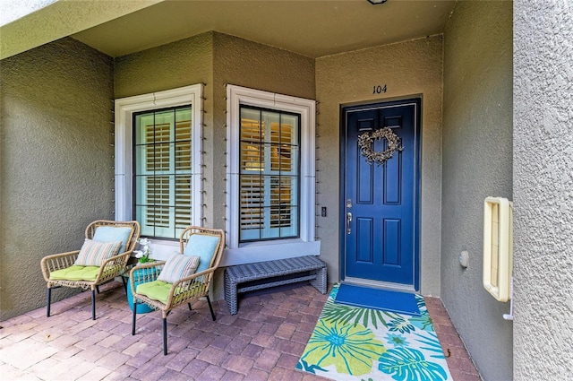 13609 Messina Loop Unit 104, Bradenton, FL 34211 - view of exterior entry featuring stucco siding and covered porch