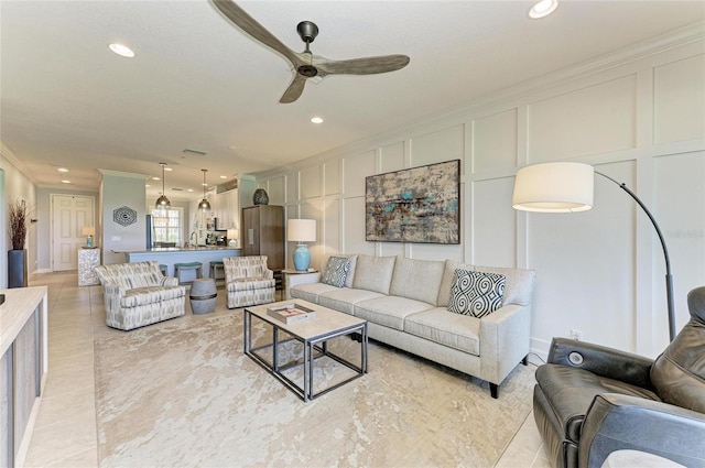13609 Messina Loop Unit 104, Bradenton, FL 34211 - living room featuring ornamental molding, a ceiling fan, recessed lighting, a decorative wall, and light tile patterned floors