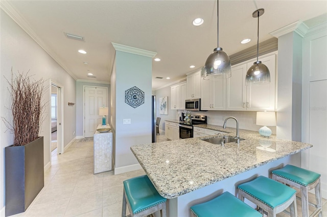 13609 Messina Loop Unit 104, Bradenton, FL 34211 - kitchen with appliances with stainless steel finishes, a sink, ornamental molding, light stone countertops, and baseboards