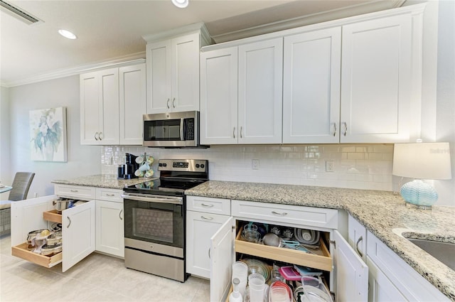13609 Messina Loop Unit 104, Bradenton, FL 34211 - kitchen with appliances with stainless steel finishes, crown molding, white cabinetry, backsplash, and recessed lighting