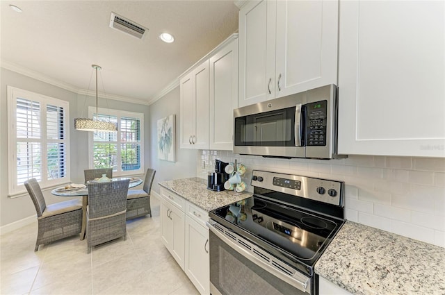 13609 Messina Loop Unit 104, Bradenton, FL 34211 - kitchen with appliances with stainless steel finishes, crown molding, white cabinetry, backsplash, and recessed lighting
