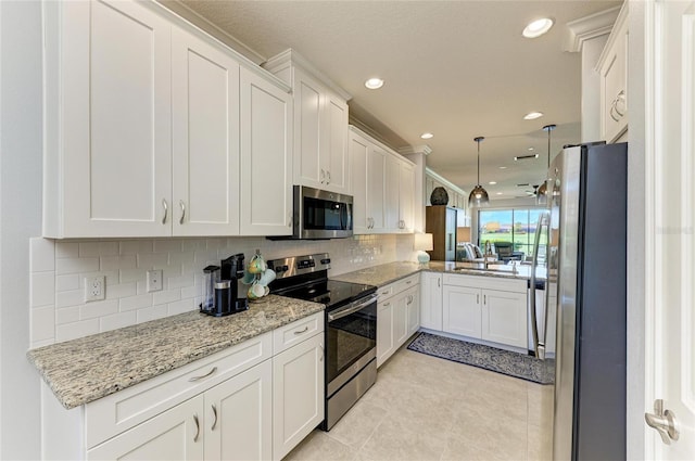 13609 Messina Loop Unit 104, Bradenton, FL 34211 - kitchen featuring appliances with stainless steel finishes, tasteful backsplash, white cabinetry, light tile patterned floors, and recessed lighting