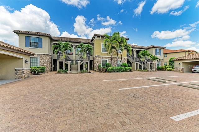 13609 Messina Loop Unit 104, Bradenton, FL 34211 - multi unit property featuring stairs, stone siding, stucco siding, and uncovered parking